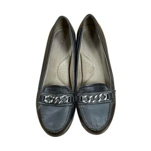 Black low-heel loafers with silver chain trim and cushioned instep and footbed.